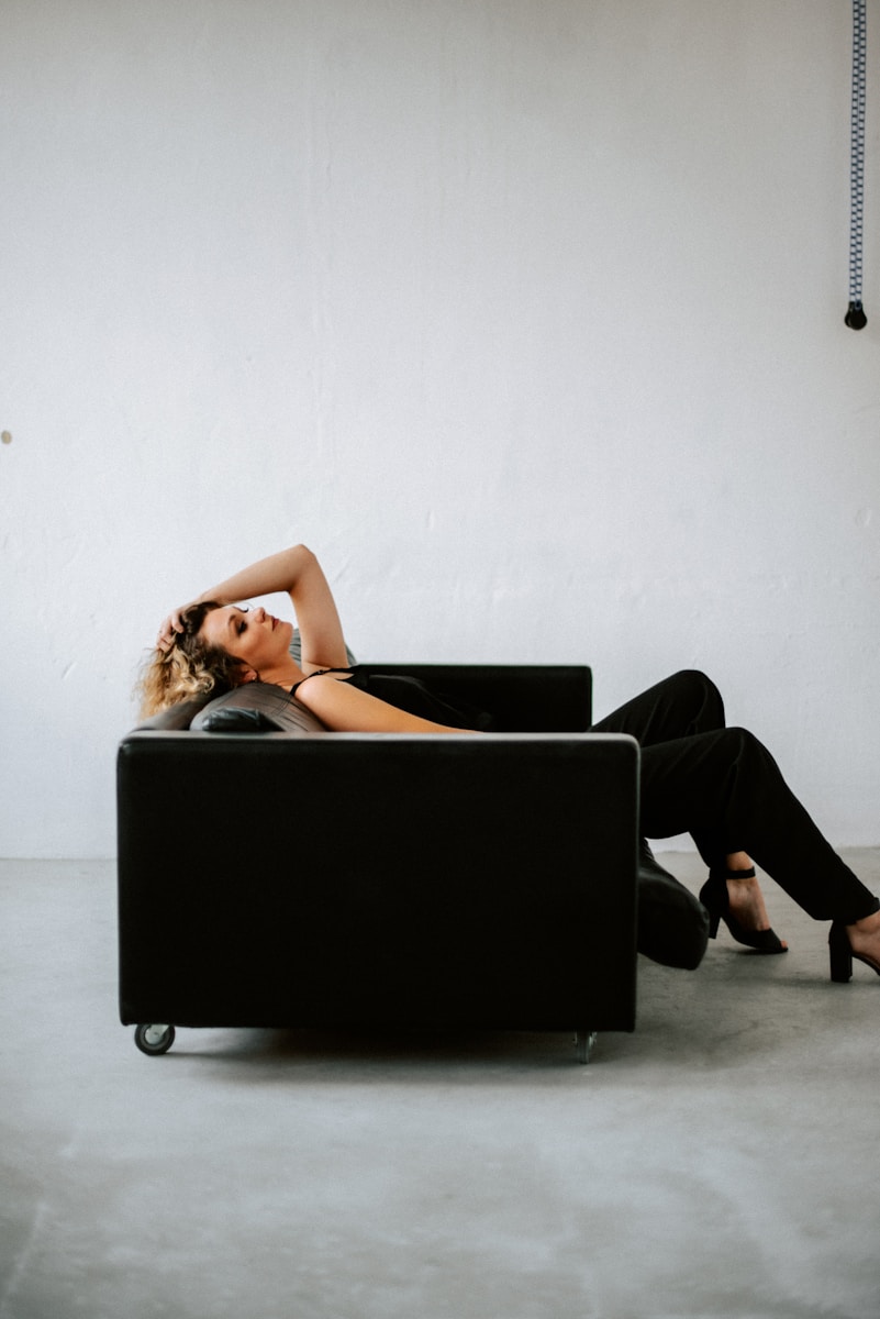 a woman laying on a couch in a room